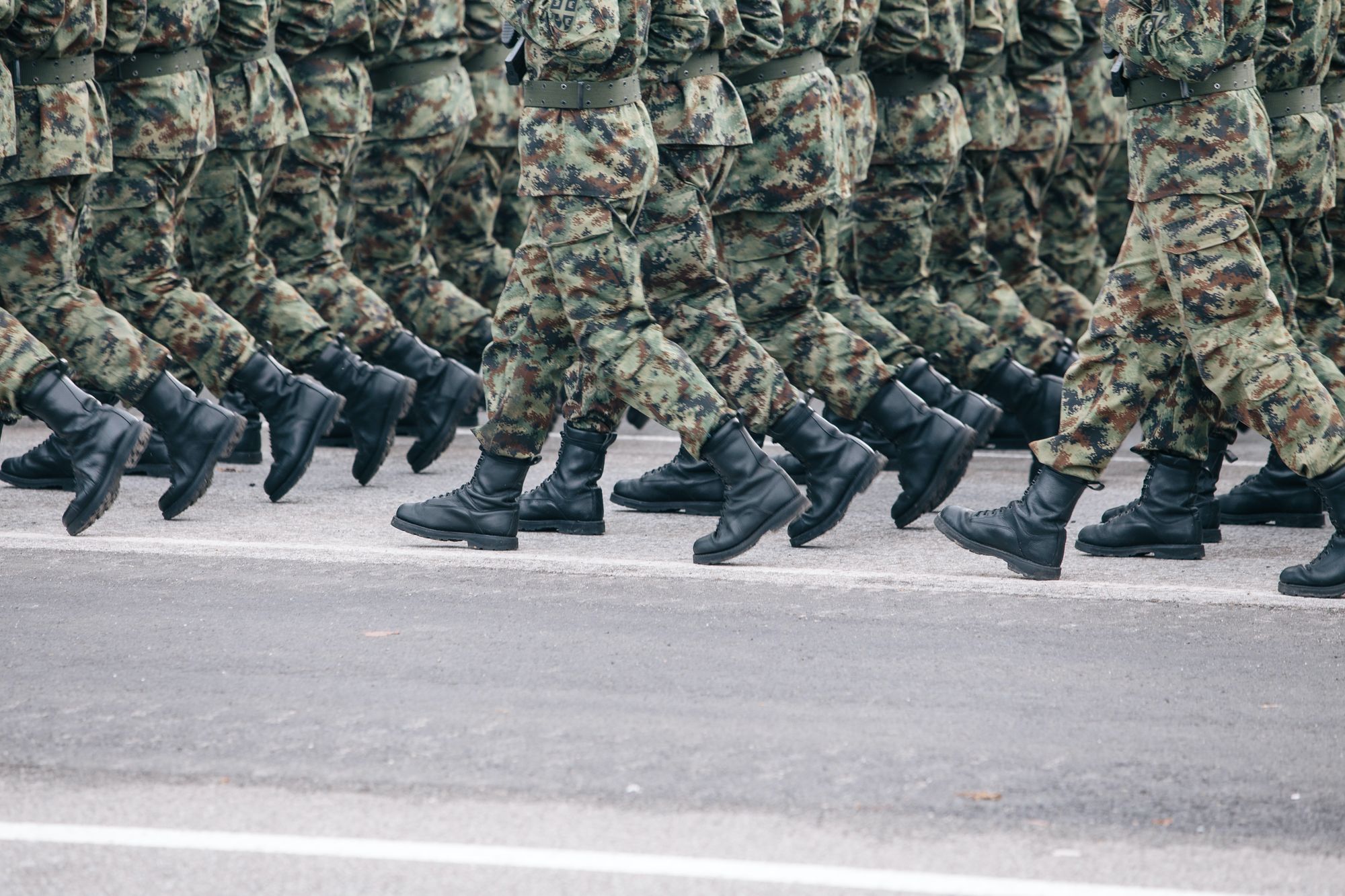 Photo of marching soldiers from the waist down.
